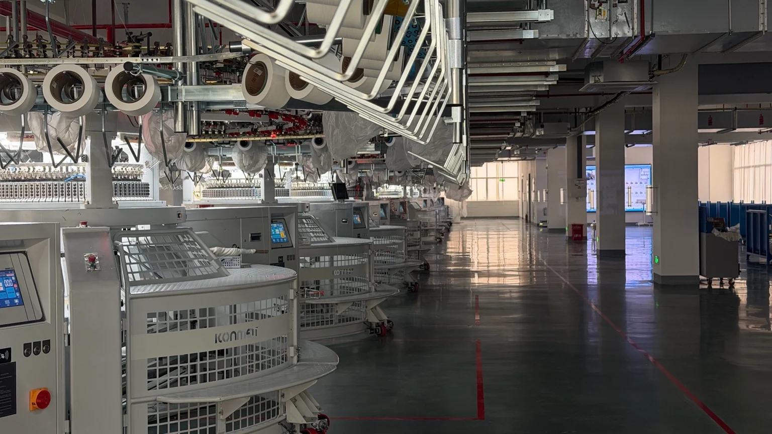 Rows of circular knitting machines on the workshop floor